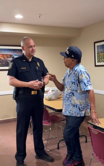 Police officer speaking with a man.