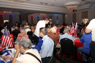Residents at the Fourth of July party visiting.