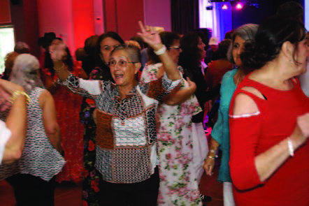 A woman dancing in the crowd.