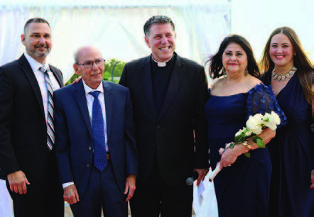 A group of individuals standing with the marriage officiant.