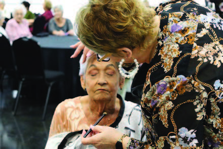 A woman having her makeup done.