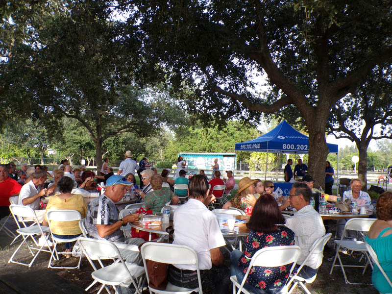 Tables full of people eating and visiting.