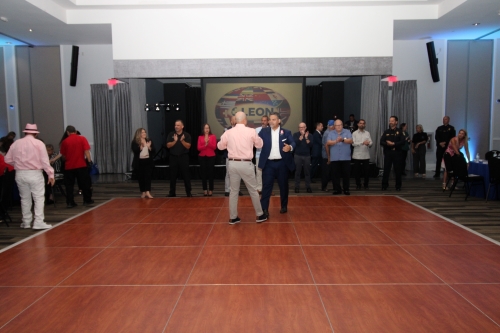 Two men shaking hands on the dance floor.