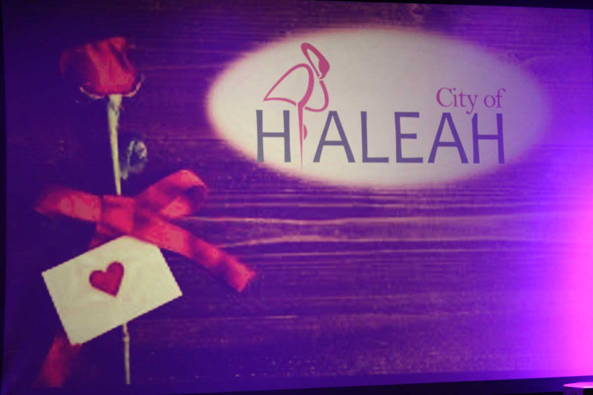 City of Hiahleah text next to a picture of a rose with a card.