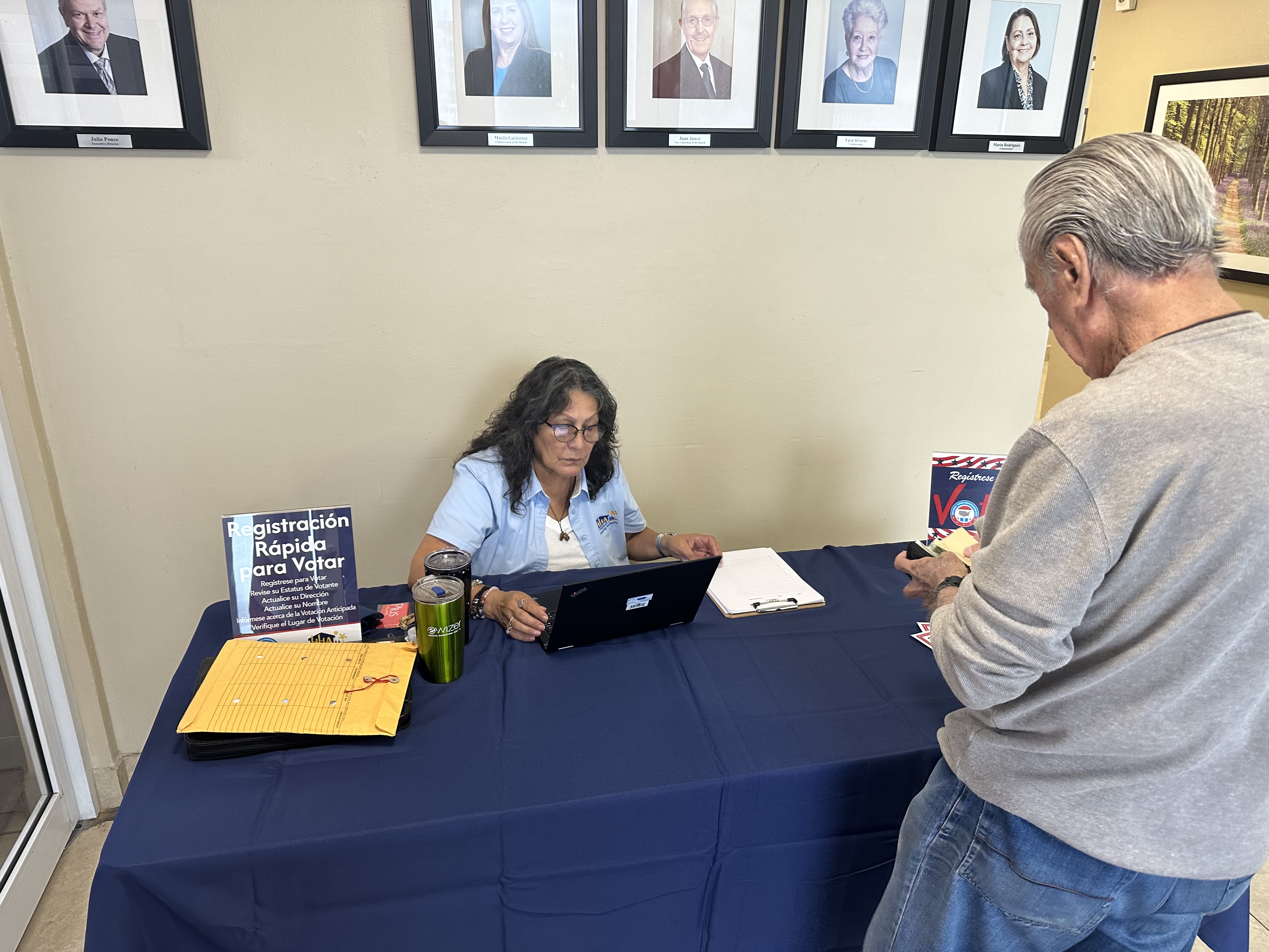 Woman helping a man getting information from a man.