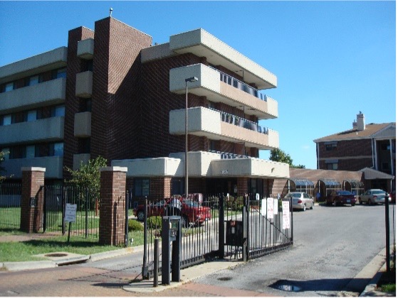 A large building with a black gate in the front.