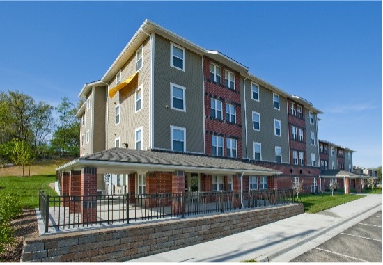 A beautiful apartment building with brick and vinyl siding.