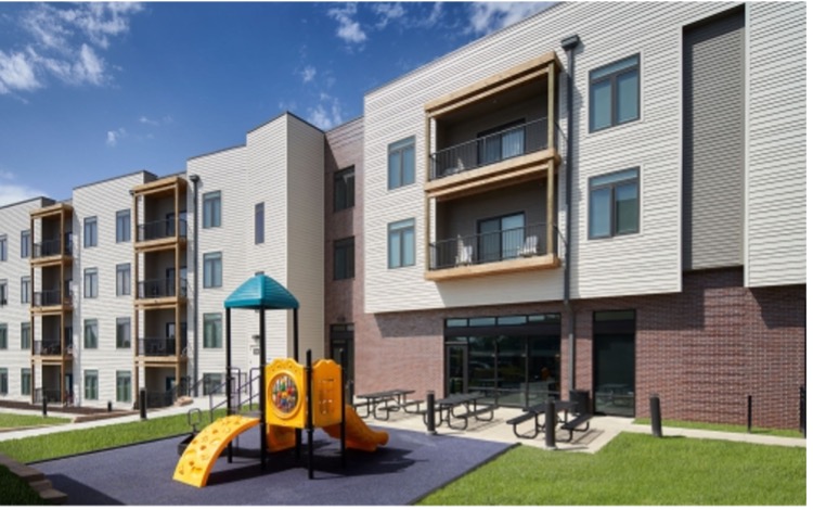 An apartment building with a playground out front.