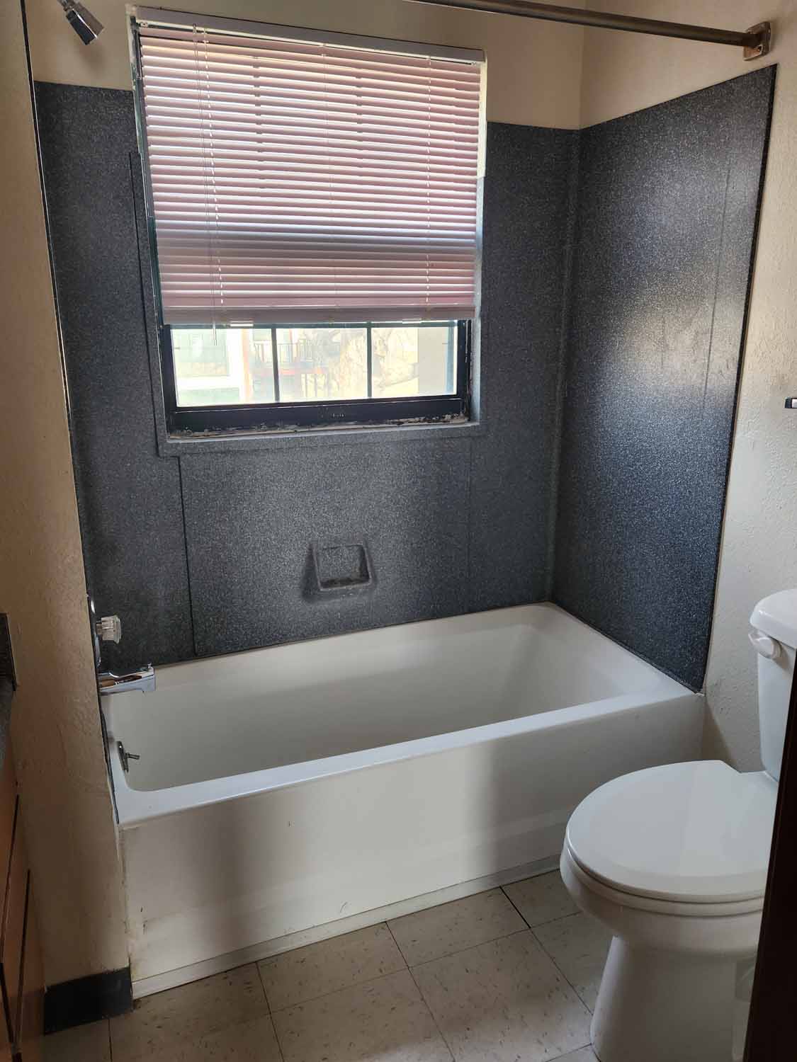 A bathroom with view of the bathtub.