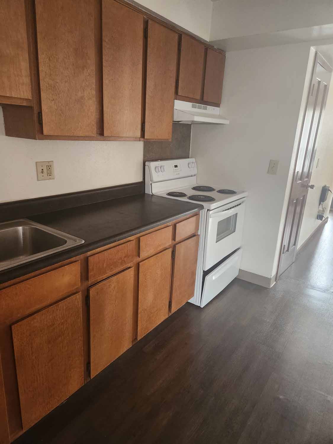 A beautiful kitchen with hard wood flooring.