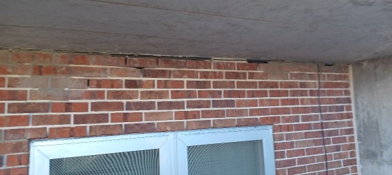 View of brick veneer masonry to replace and repoint with shear crack.