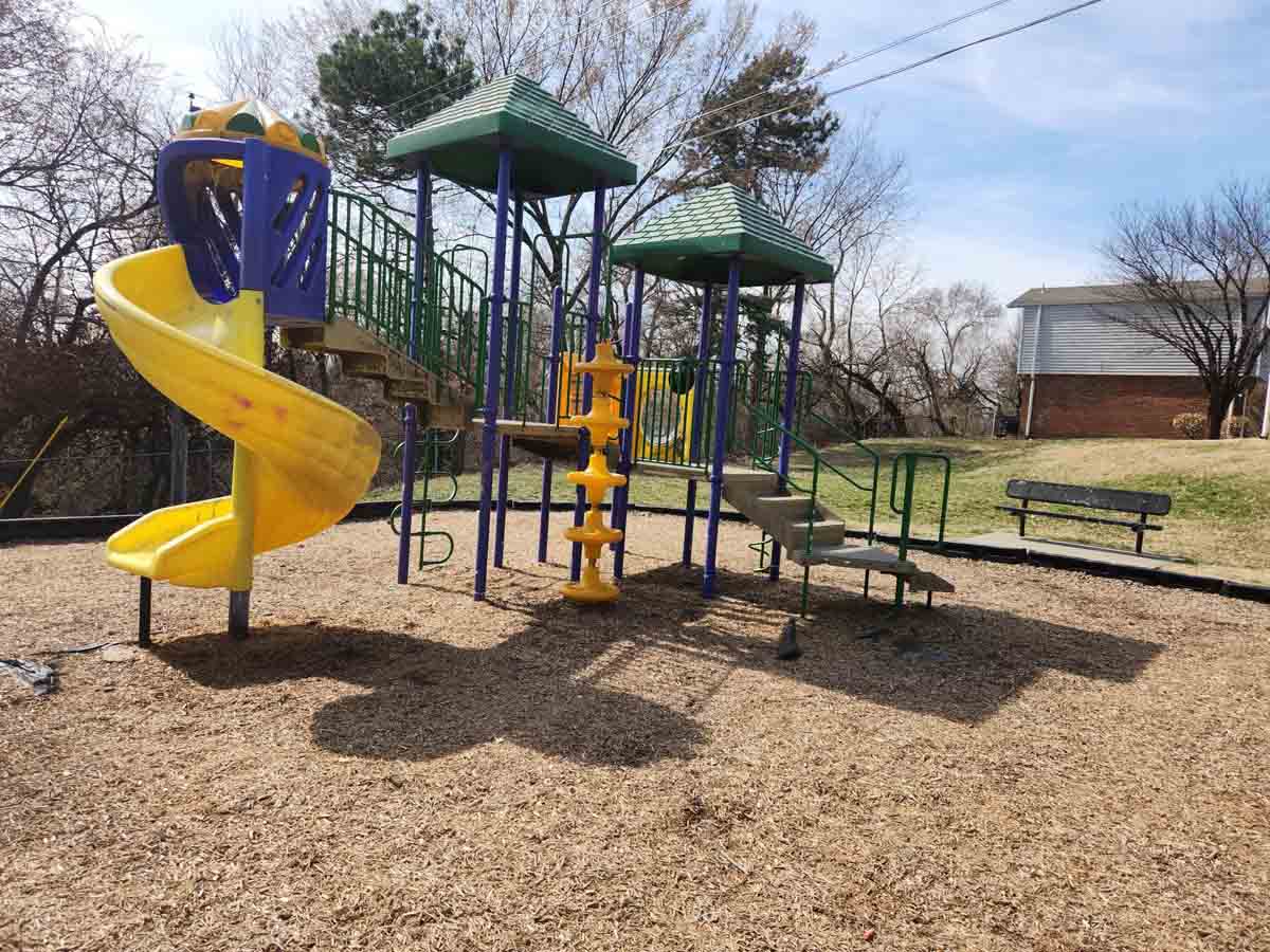 A playground with a yellow slide.