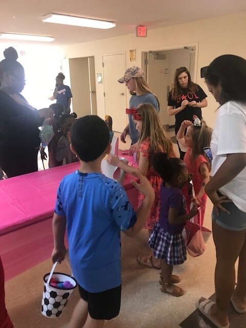 Adults and children around a table.