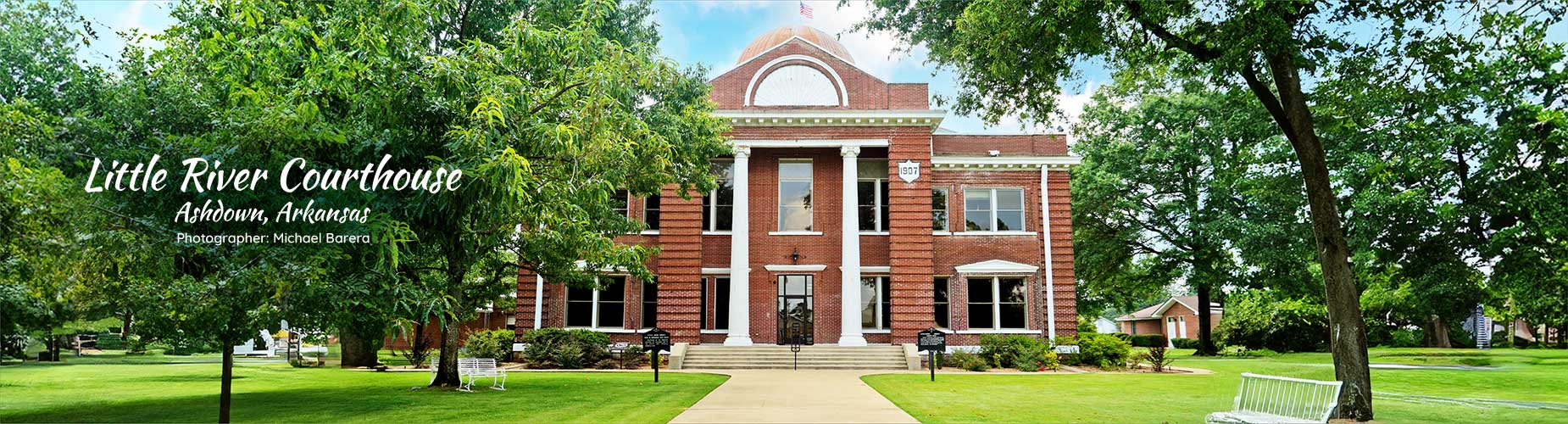 Little River Courthouse, Ashdown, Arkansas, Photographer Michael Barera with the courthouse surrounded by trees in the background.