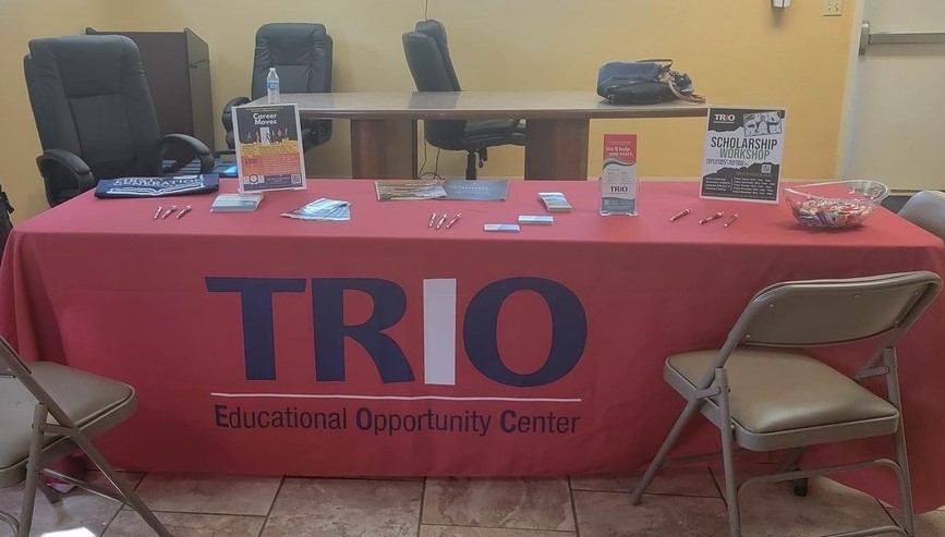 TRIO table set up with chairs and information  for people interested in signing up for their scholarship.