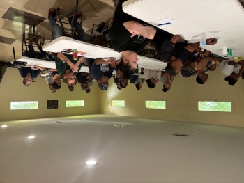 Tables full of people sitting in a room.