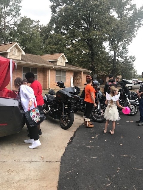 Trunk or Treat vehicle with kids trick or treating. Motorcycles with their riders.