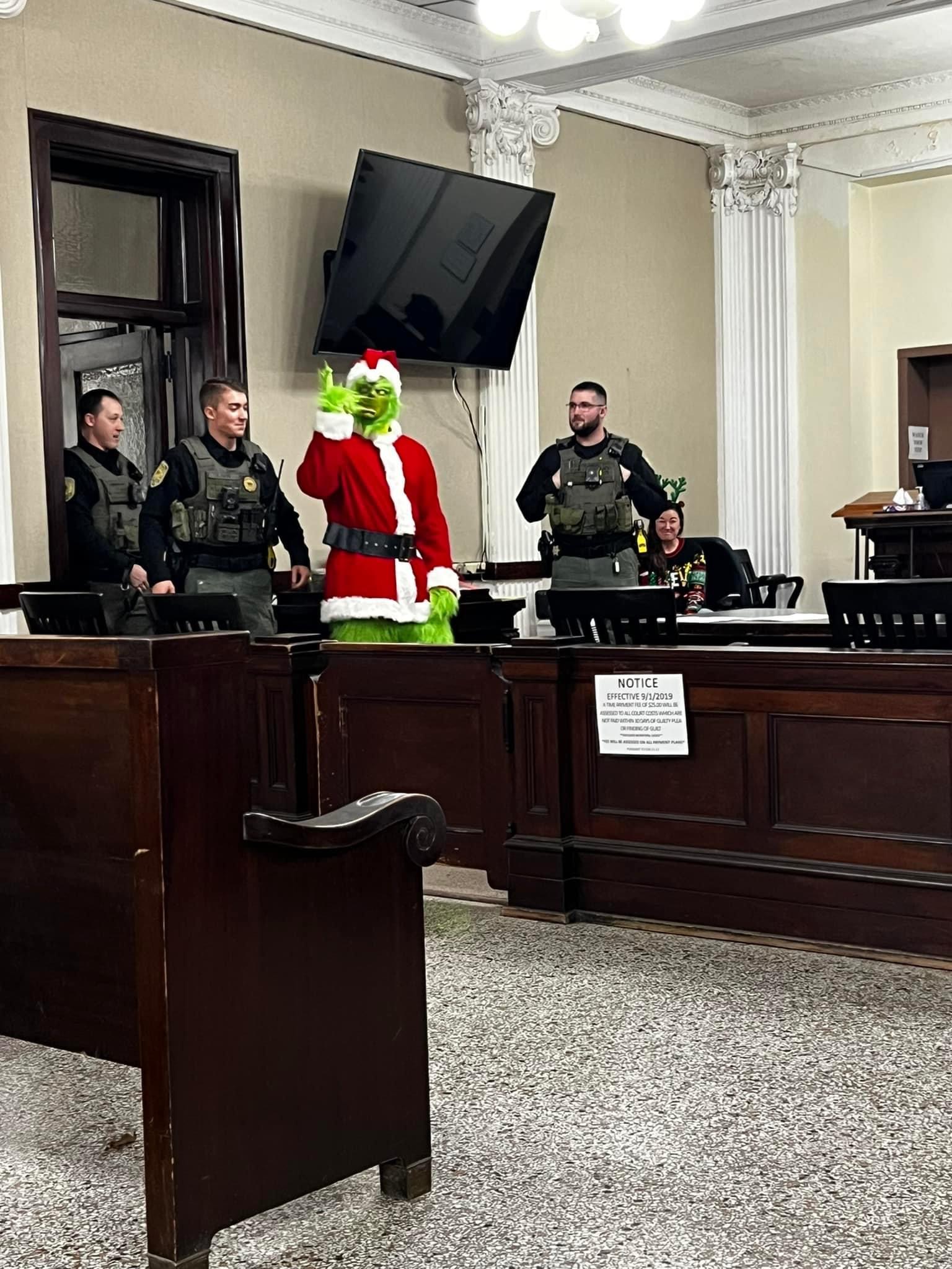 The Grinch being escorted into the courtroom by LCSO staff