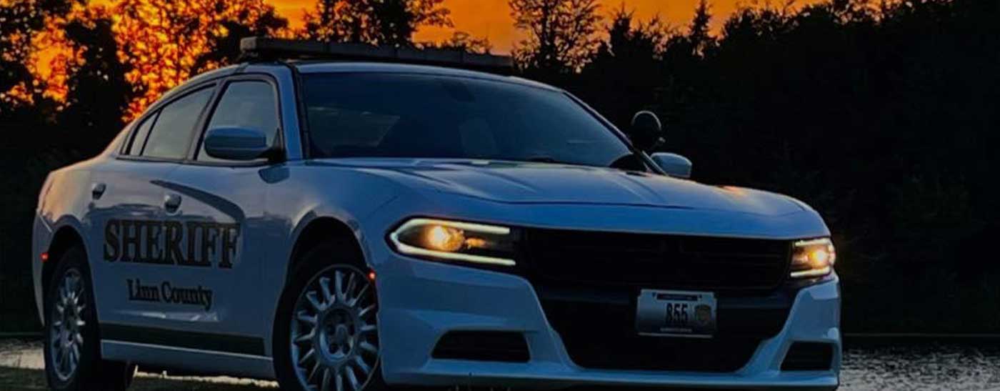 Dodge Charger sitting in front of pond at sunset