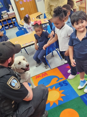 K9 Dally and Officer Zeke Sampey in a classroom of elementary students