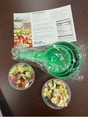 Filled small containers with a recipe and measuring cups.