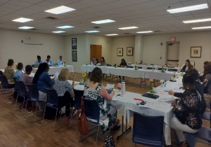 People seated at tables taking part in the FSS Program.