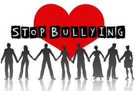 Stop Bullying - A group of people silhouettes holding hands in front of a heart.