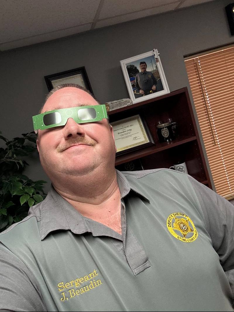 Sergeant Beaudin wearing solar eclipse glasses.