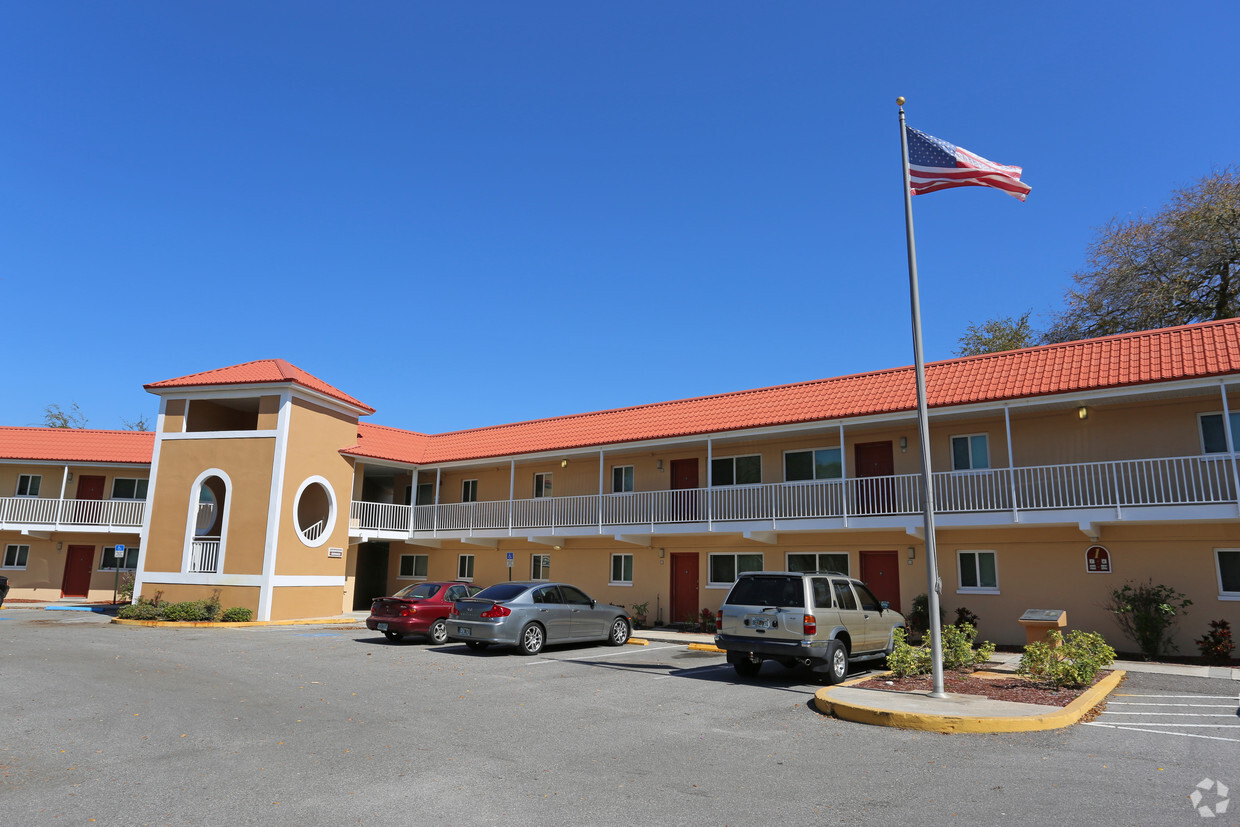 Arbors Apartment building with a red roof.