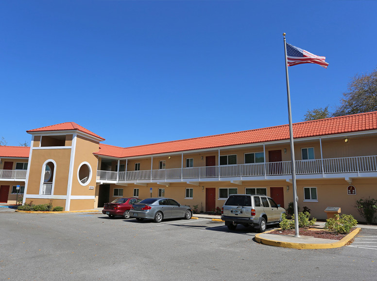 An apartment building with a red roof.