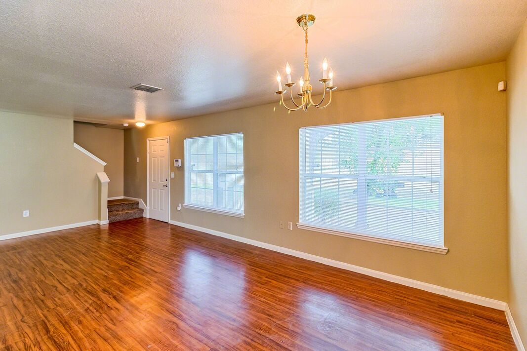 A living room area with hardwood floors.