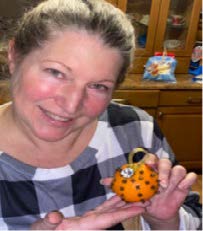 A woman holding a gift bag.