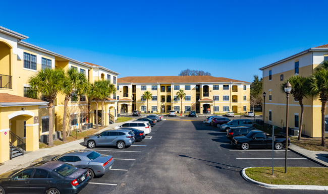 A large parking lot with a few cars parked.