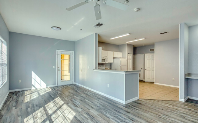 A dining room and kitchen in Gardens at South Bay.