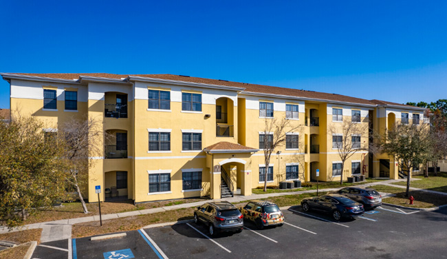 A large yelow apartment building.