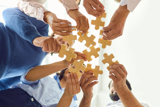 People holding puzzle pieces