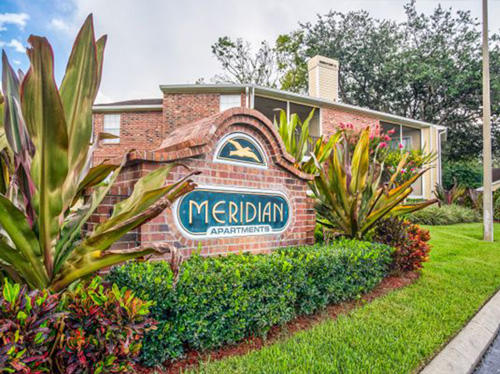 An apartment complex sign that reads Meridian Apartments.