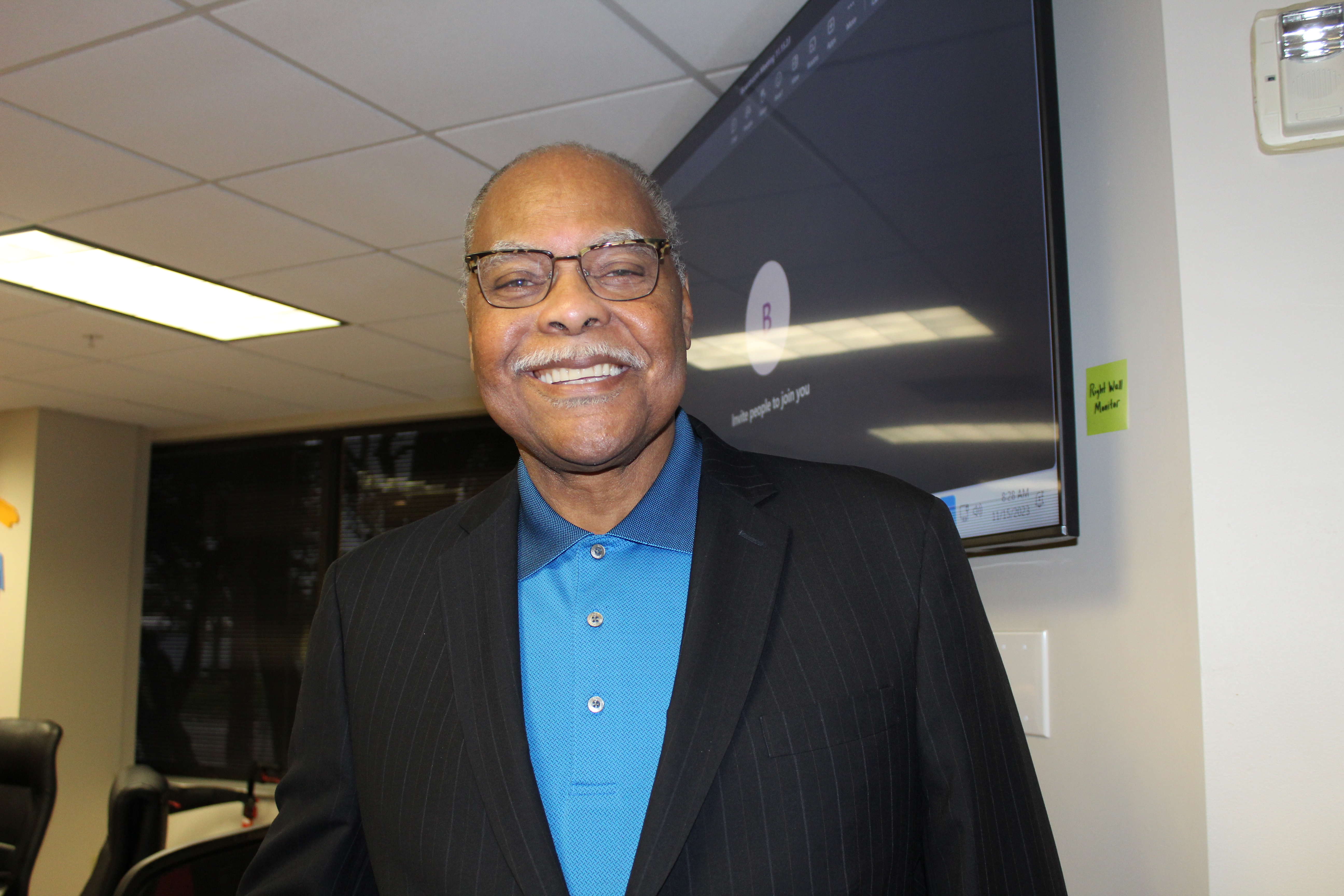 Jerome Ryans standing in front of television