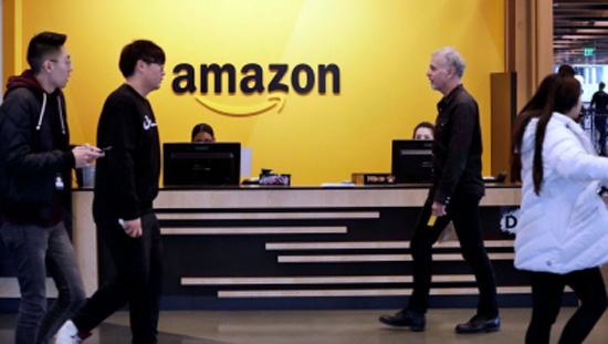 Employees walking in an Amazon office.