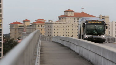 A bus driving over a bridge.