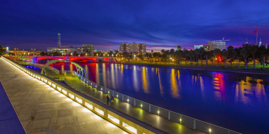 The Tampa Riverwalk, showing a lit pathway along the water.
