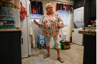A woman standing in her kitchen.