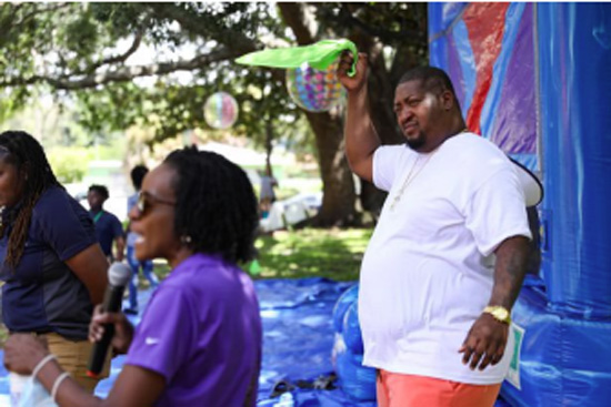 Pastor Rahman Gathers, 40, of REVIVE Church of Tampa, swings a handkerchief during Party in the Park at Fremont Linear Park on Saturday, Aug. 6, 2022 in Tampa.