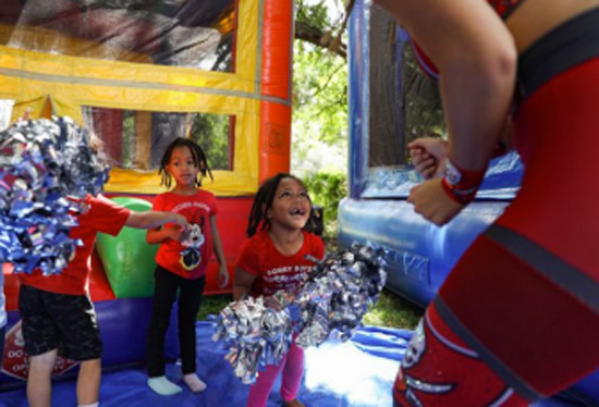 Children playing in a bouncy house.