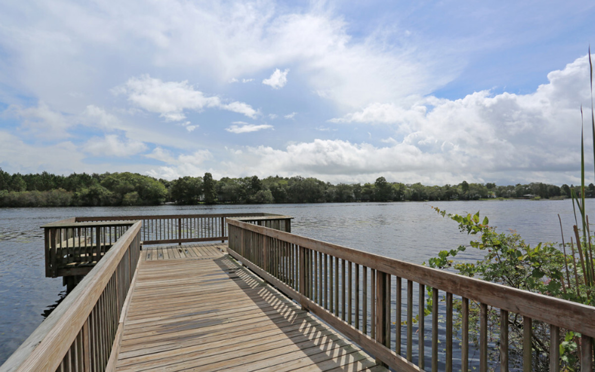 A deck that leads to a river.