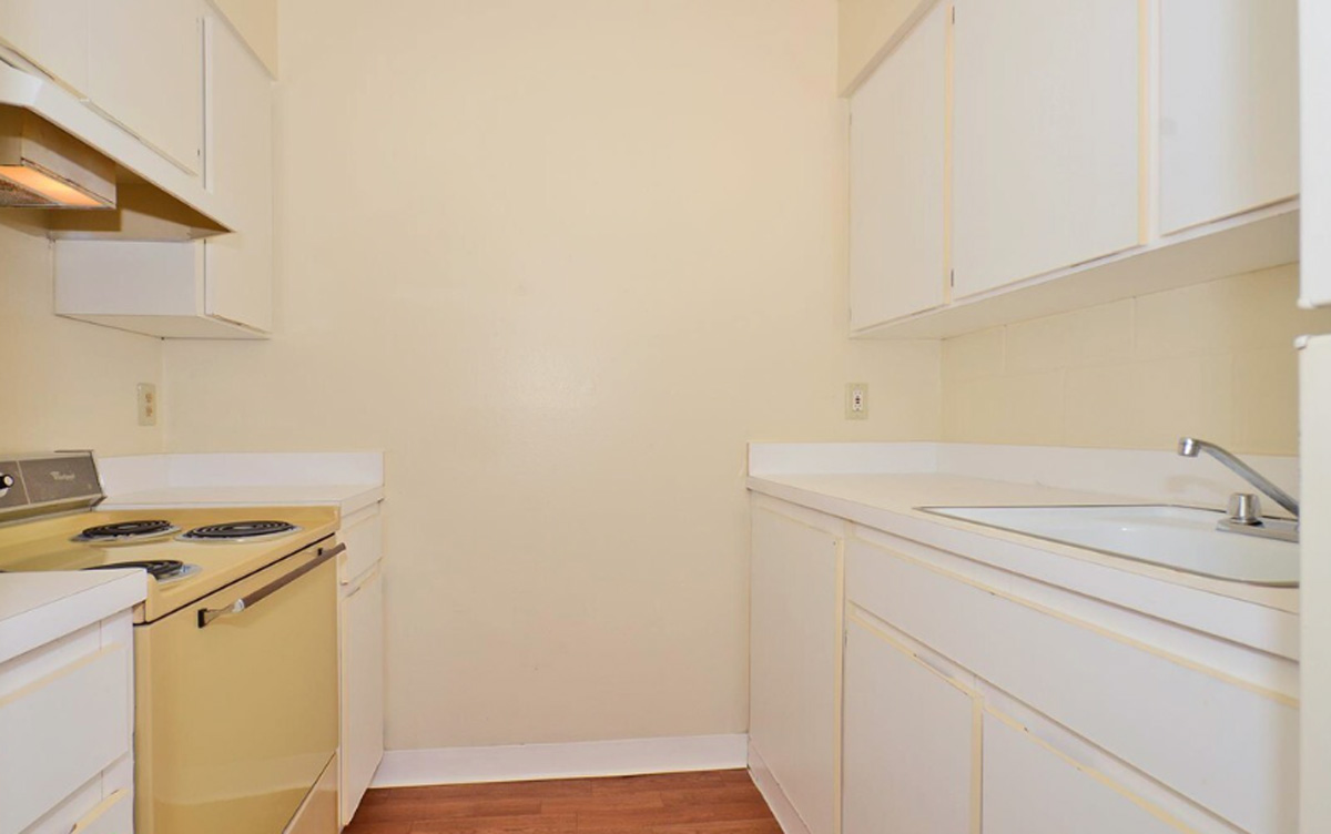 A kitchen with tan colored walls.