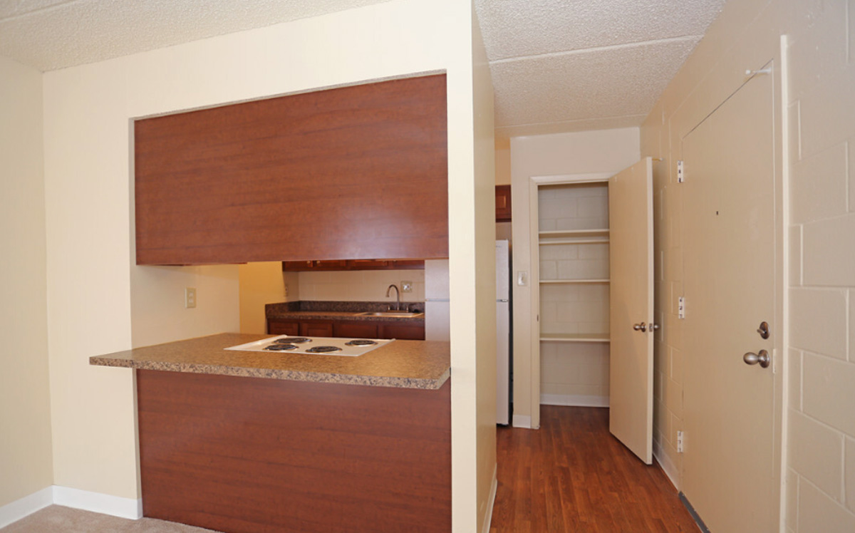 A kitchen area with a bar.