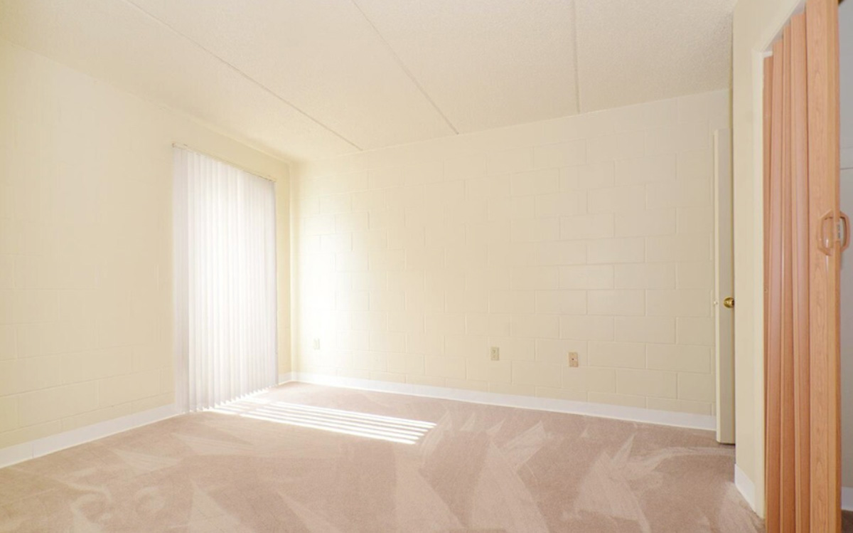 A living room with tan colored walls.