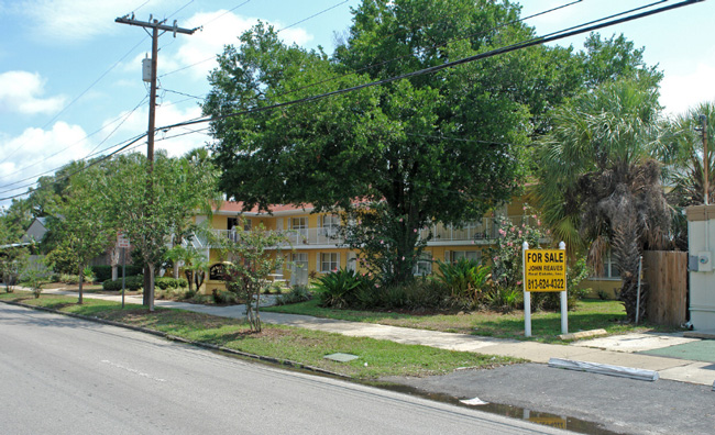 A large tree surrounding SoHo Apartments.