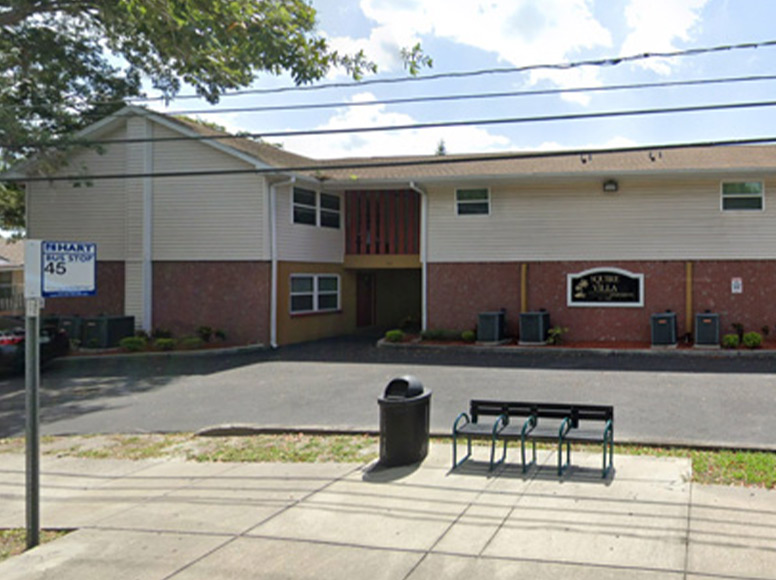 Squire Villa, a red and white apartment complex.